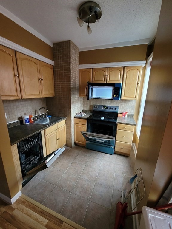140 Chestnut Street, Unit 715 Springfield, MA 01103 - Photo 6 of 13 a kitchen with stainless steel appliances a stove a microwave and a refrigerator