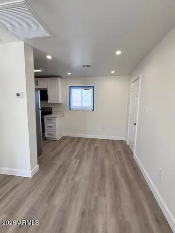 a view of a kitchen with a sink and a refrigerator