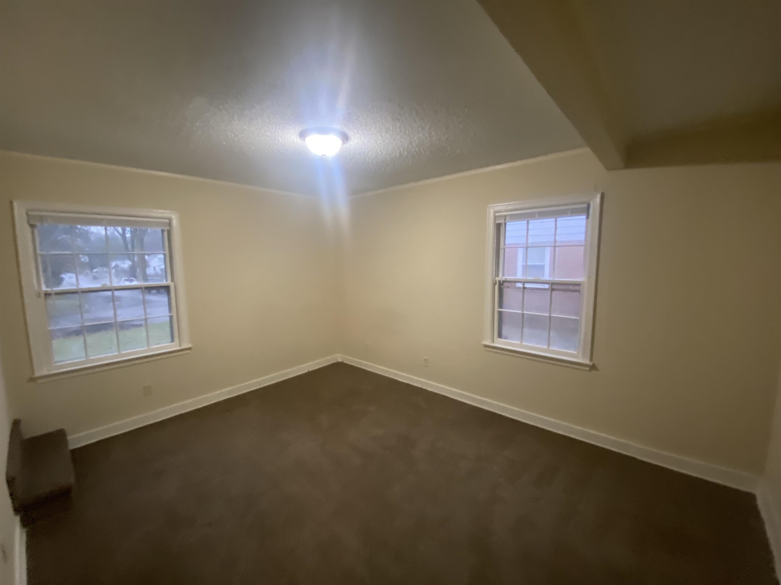 3632 Carrington Road Memphis, TN 38111 - Photo 4 of 8 an empty room with a empty space and windows