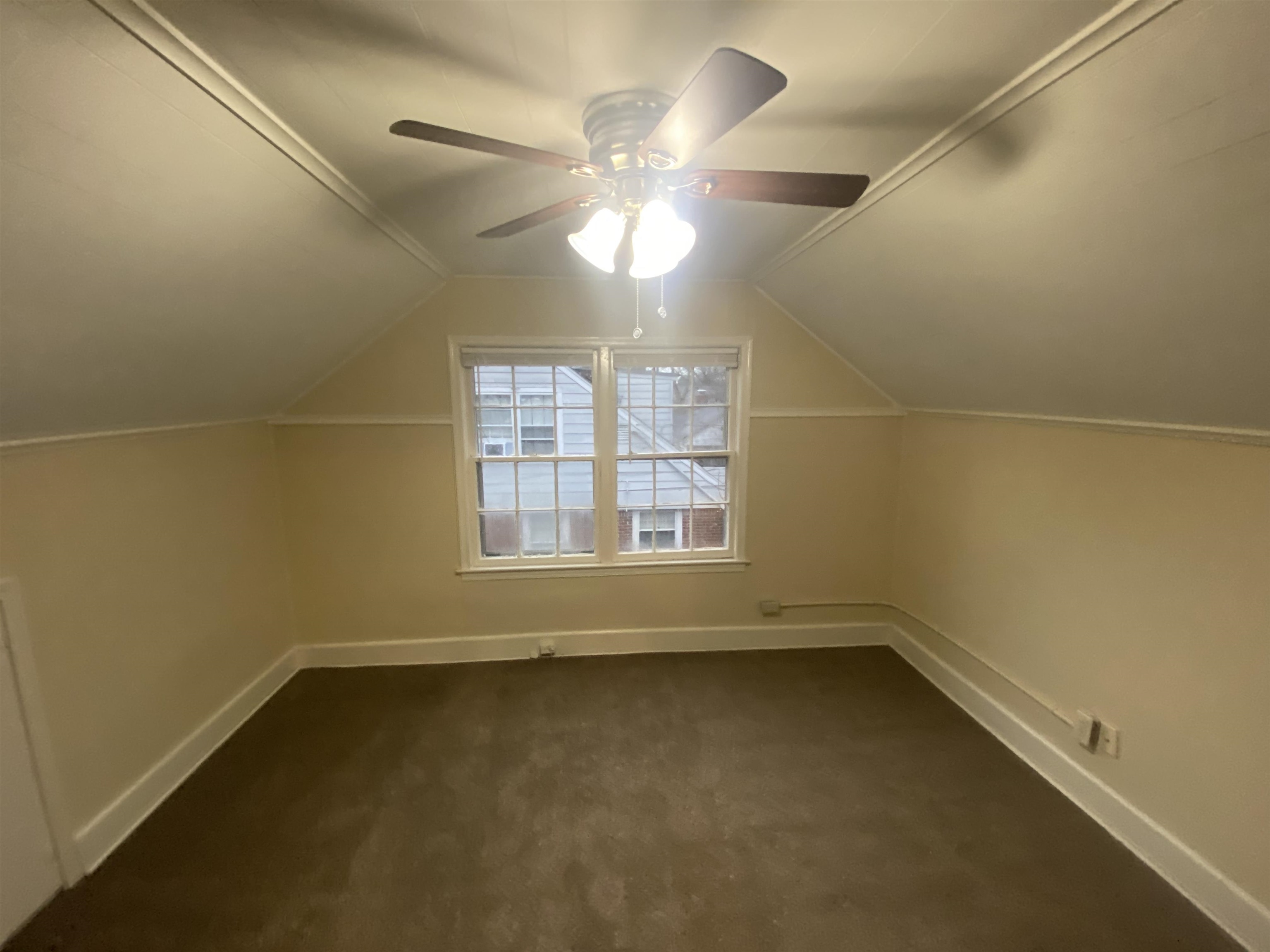 3632 Carrington Road Memphis, TN 38111 - Photo 6 of 8 an empty room with a window and a ceiling fan