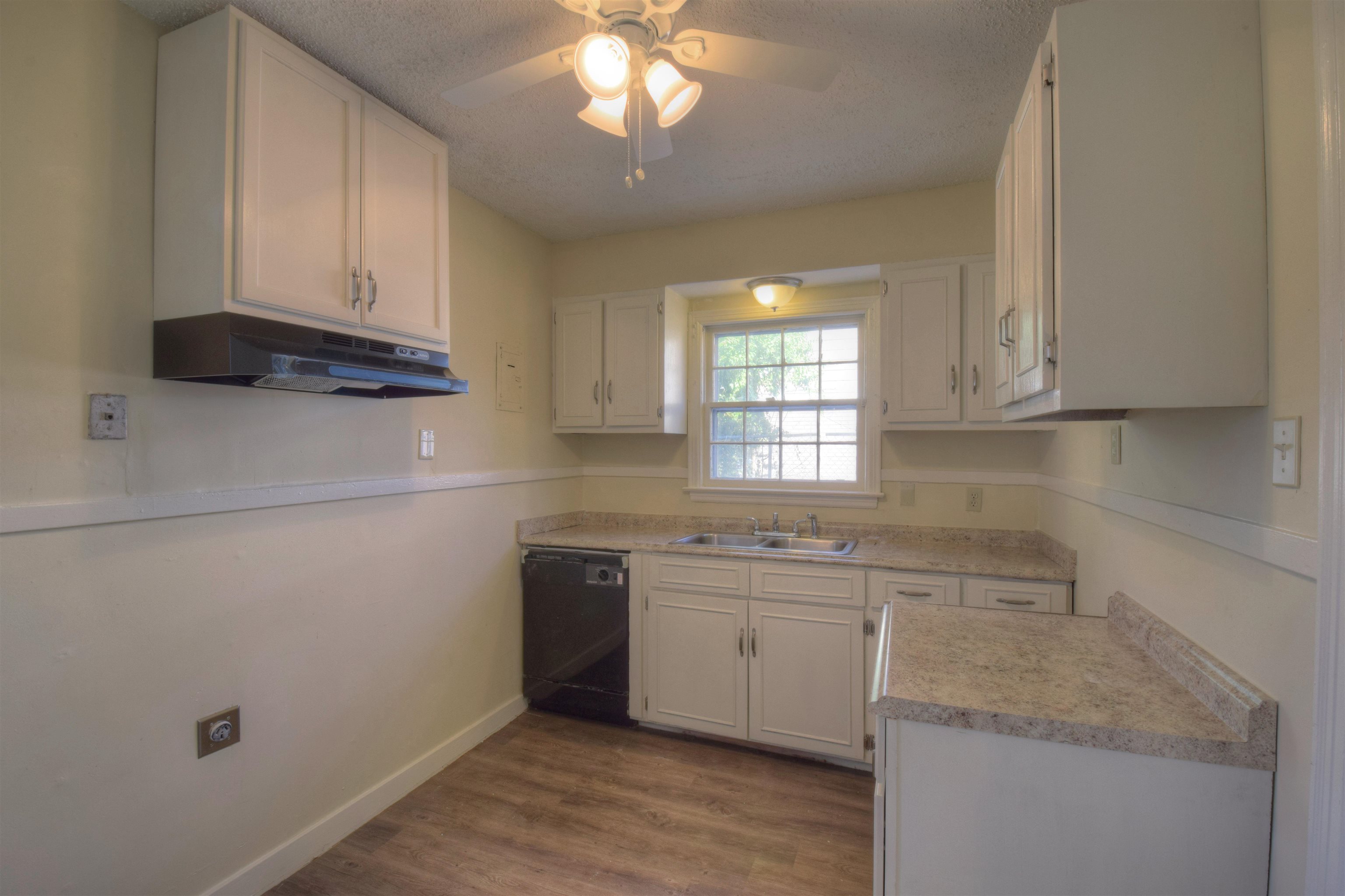 3632 Carrington Road Memphis, TN 38111 - Photo 7 of 8 a kitchen with a sink dishwasher a stove and a refrigerator