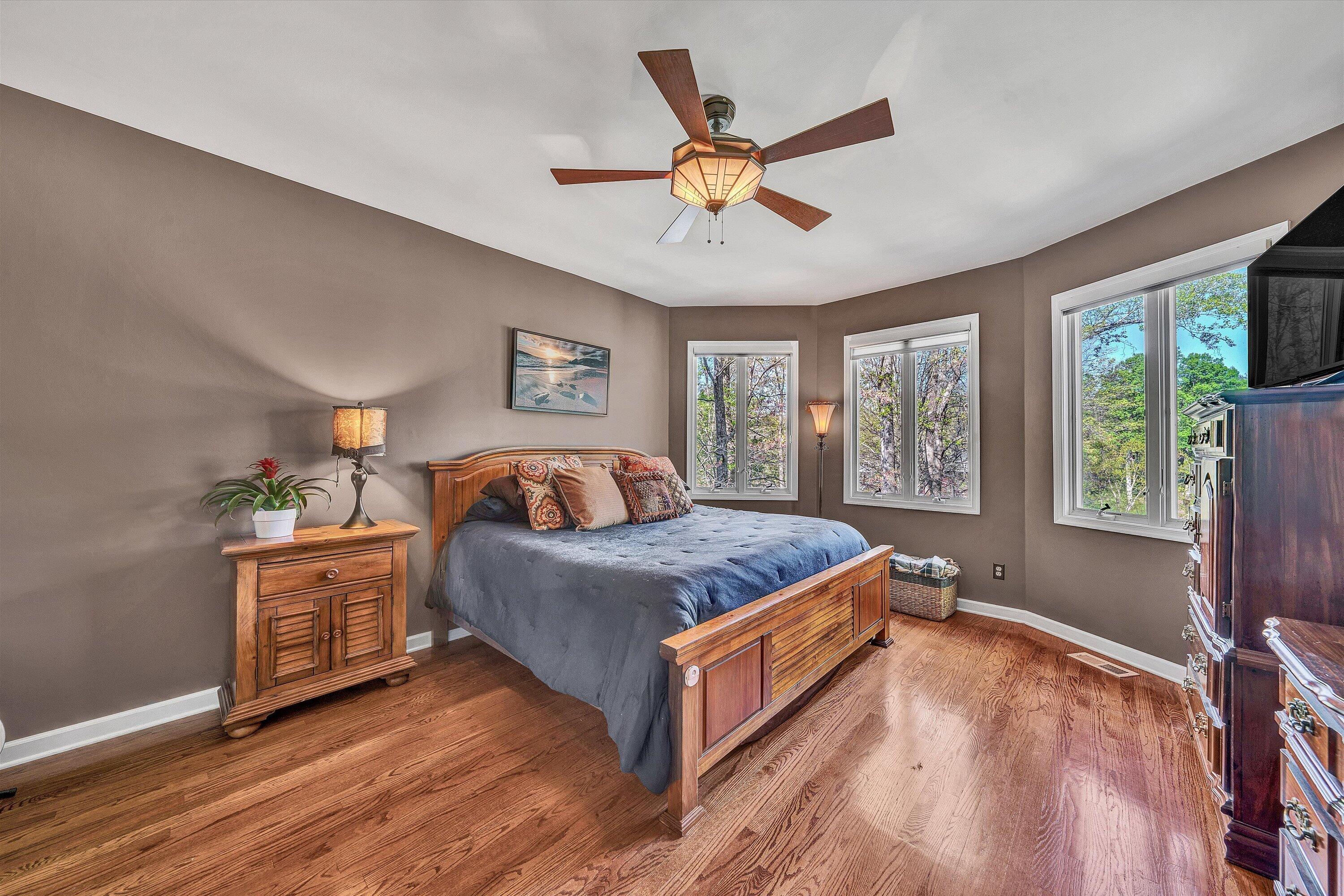 145 Channelview Drive Moneta, VA 24121 - Photo 42 of 62 a spacious bedroom with a large bed and a window