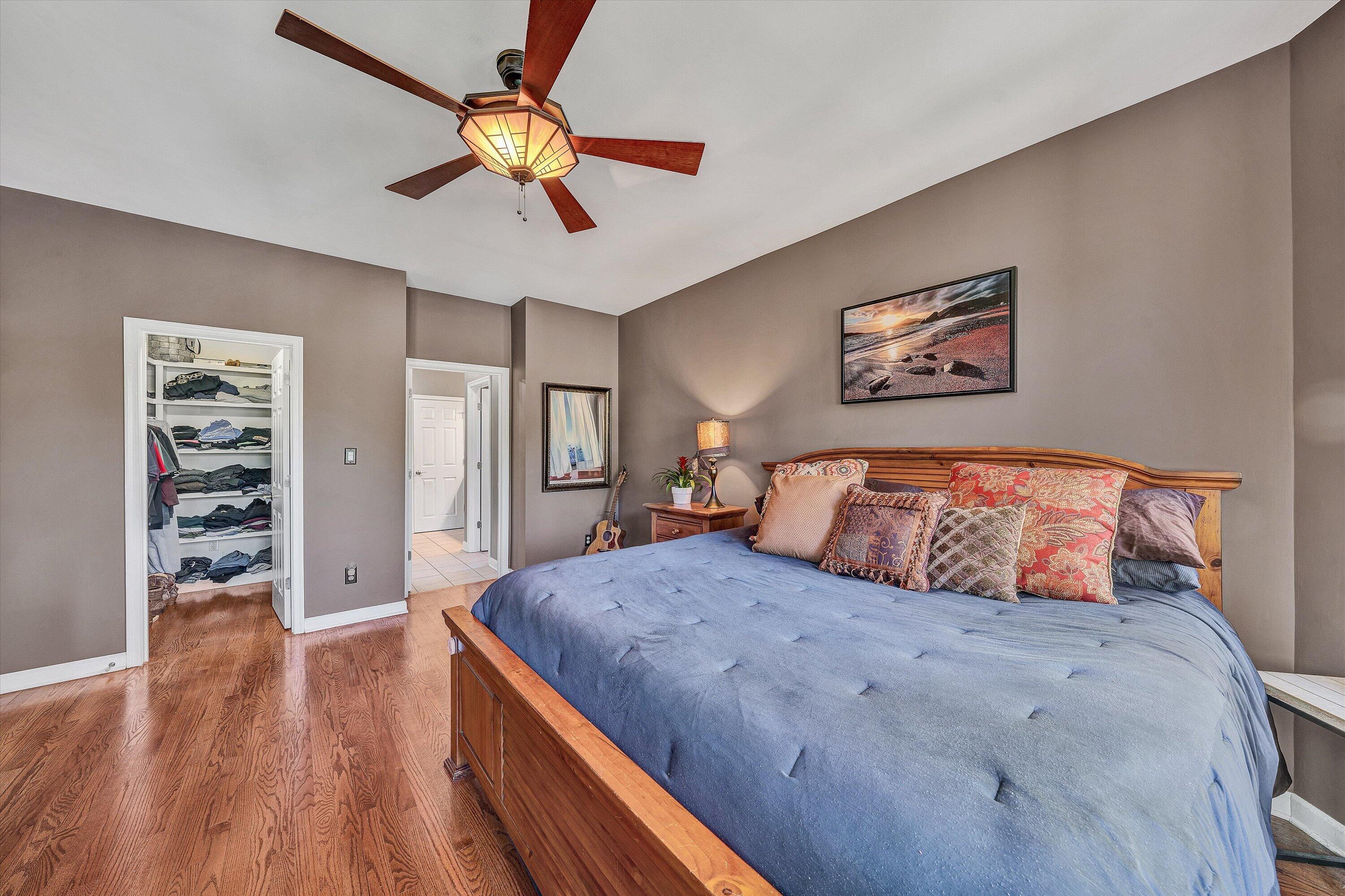 145 Channelview Drive Moneta, VA 24121 - Photo 43 of 62 a bedroom with a large bed and a chandelier