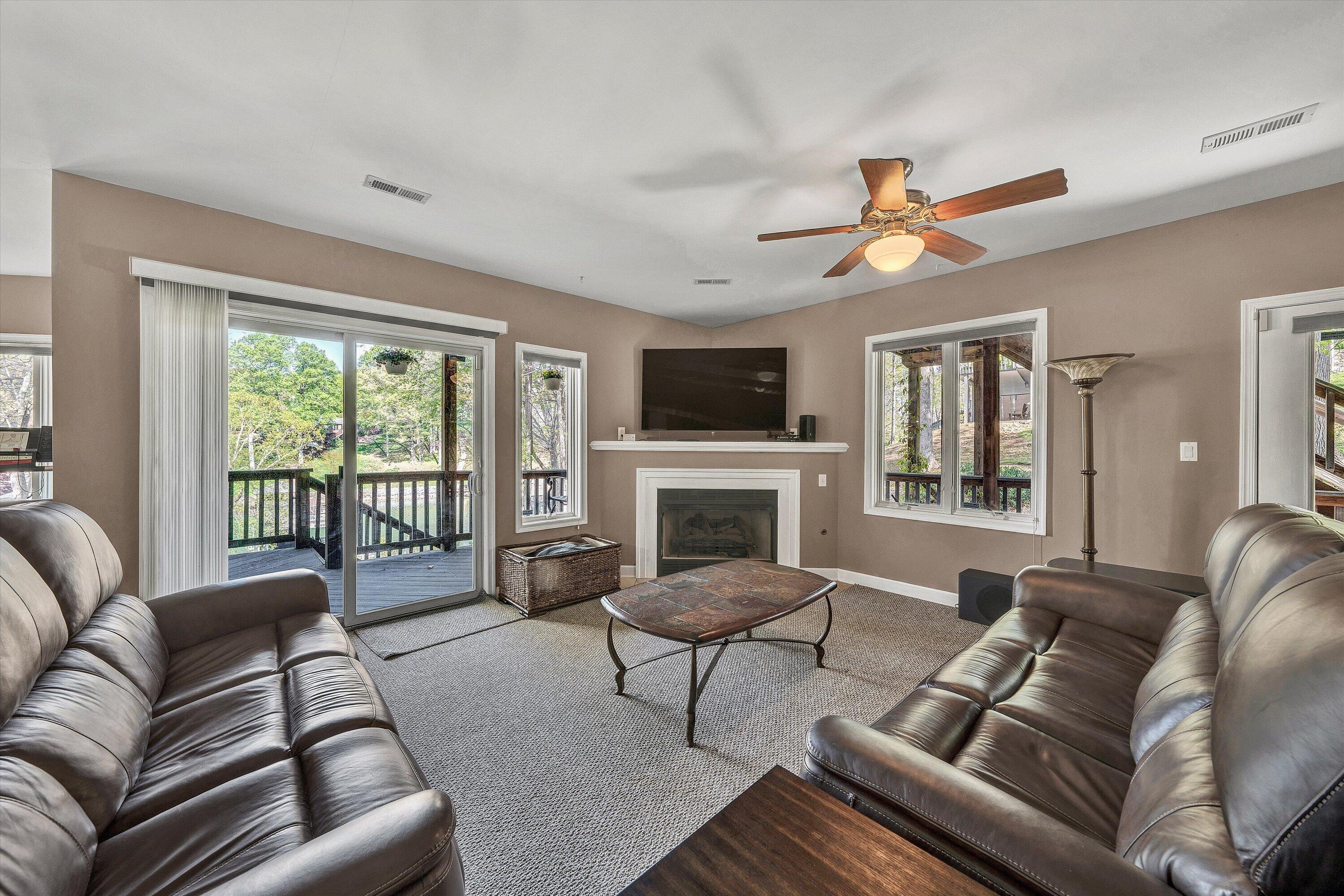 145 Channelview Drive Moneta, VA 24121 - Photo 48 of 62 a living room with furniture ceiling fan and a fireplace