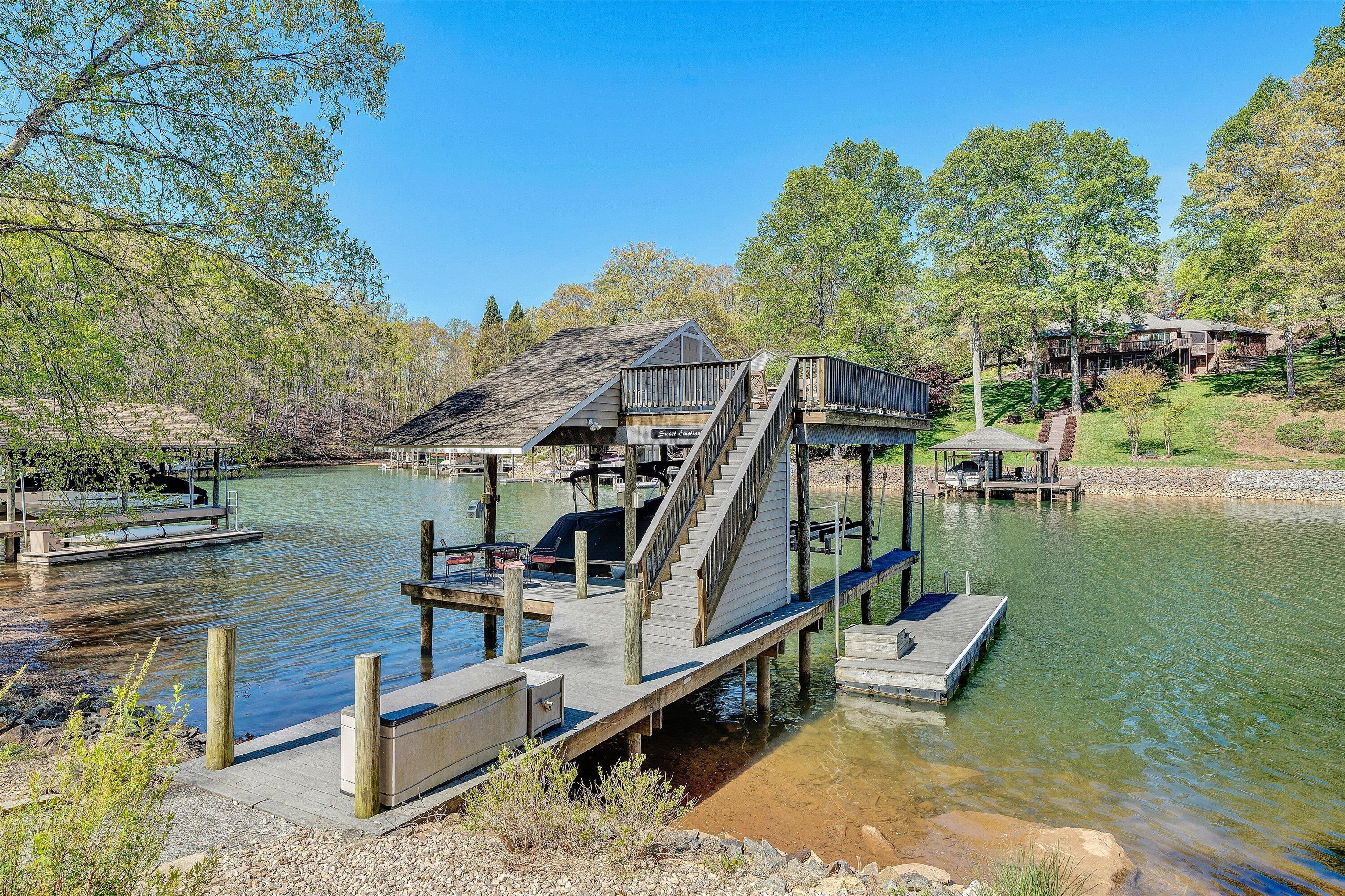 145 Channelview Drive Moneta, VA 24121 - Photo 5 of 62 a view of a lake with wooden stairs and outdoor seating