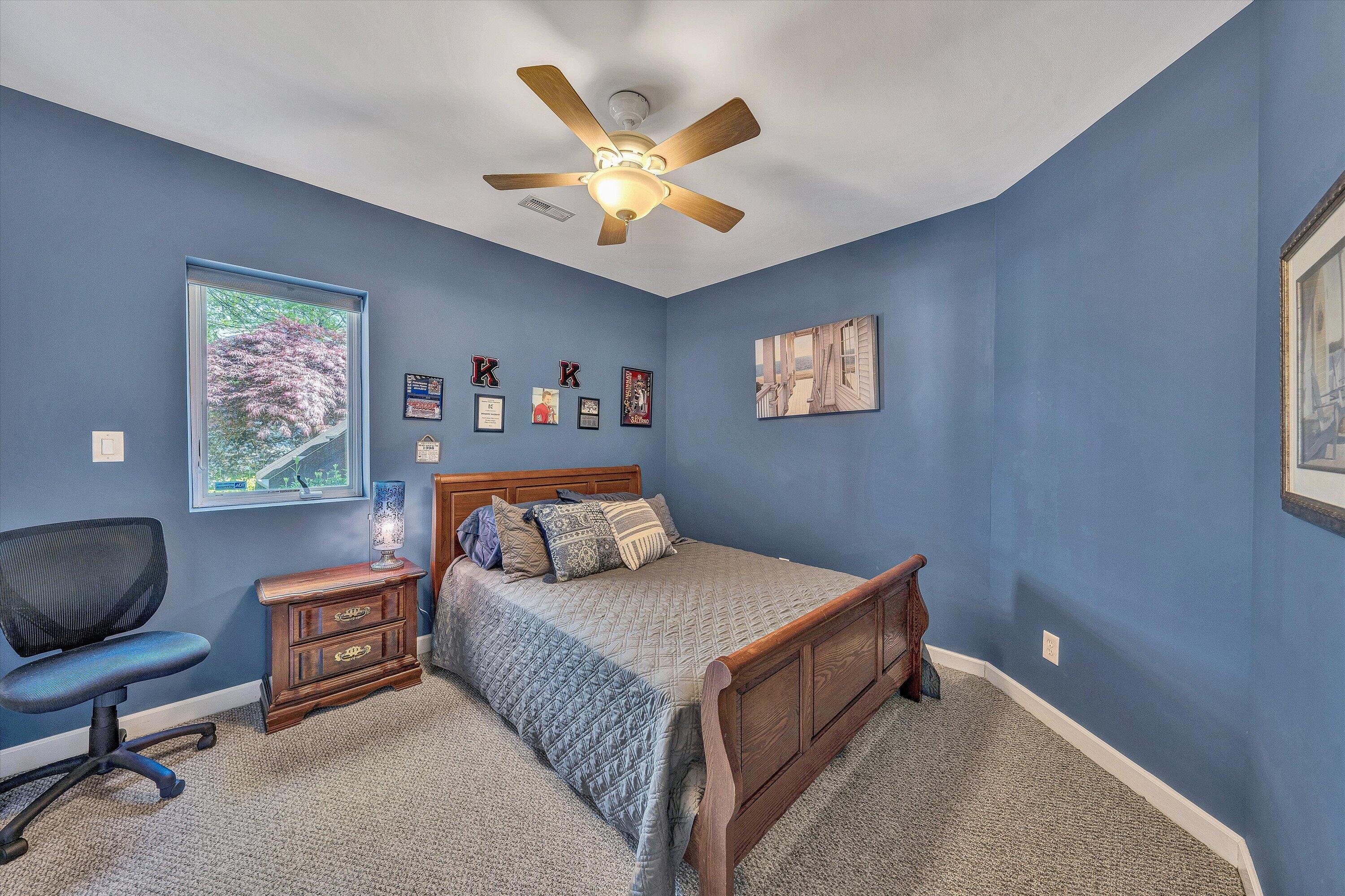 145 Channelview Drive Moneta, VA 24121 - Photo 54 of 62 a bedroom with a bed and a chandelier