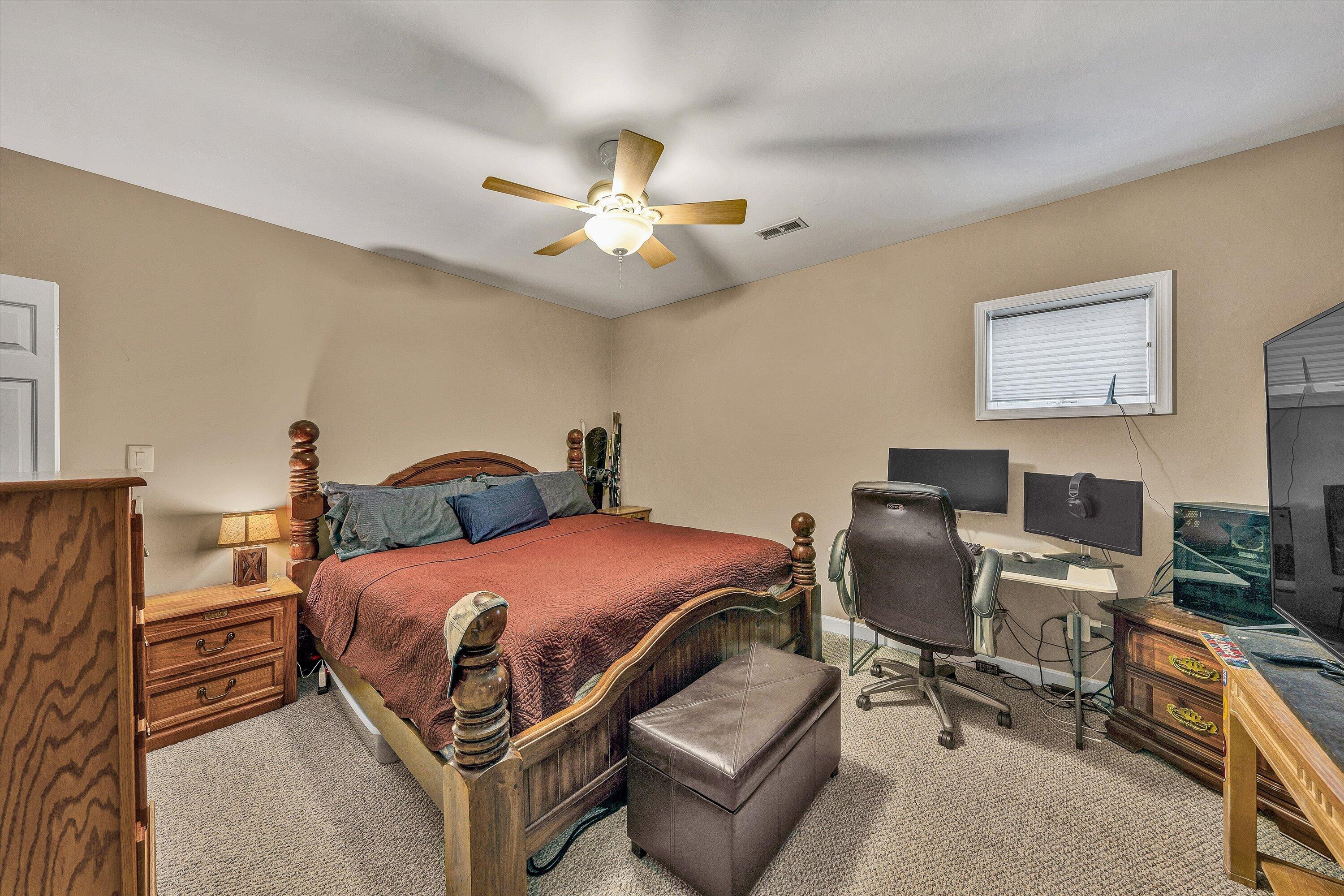 145 Channelview Drive Moneta, VA 24121 - Photo 55 of 62 a bedroom with a bed and a chandelier