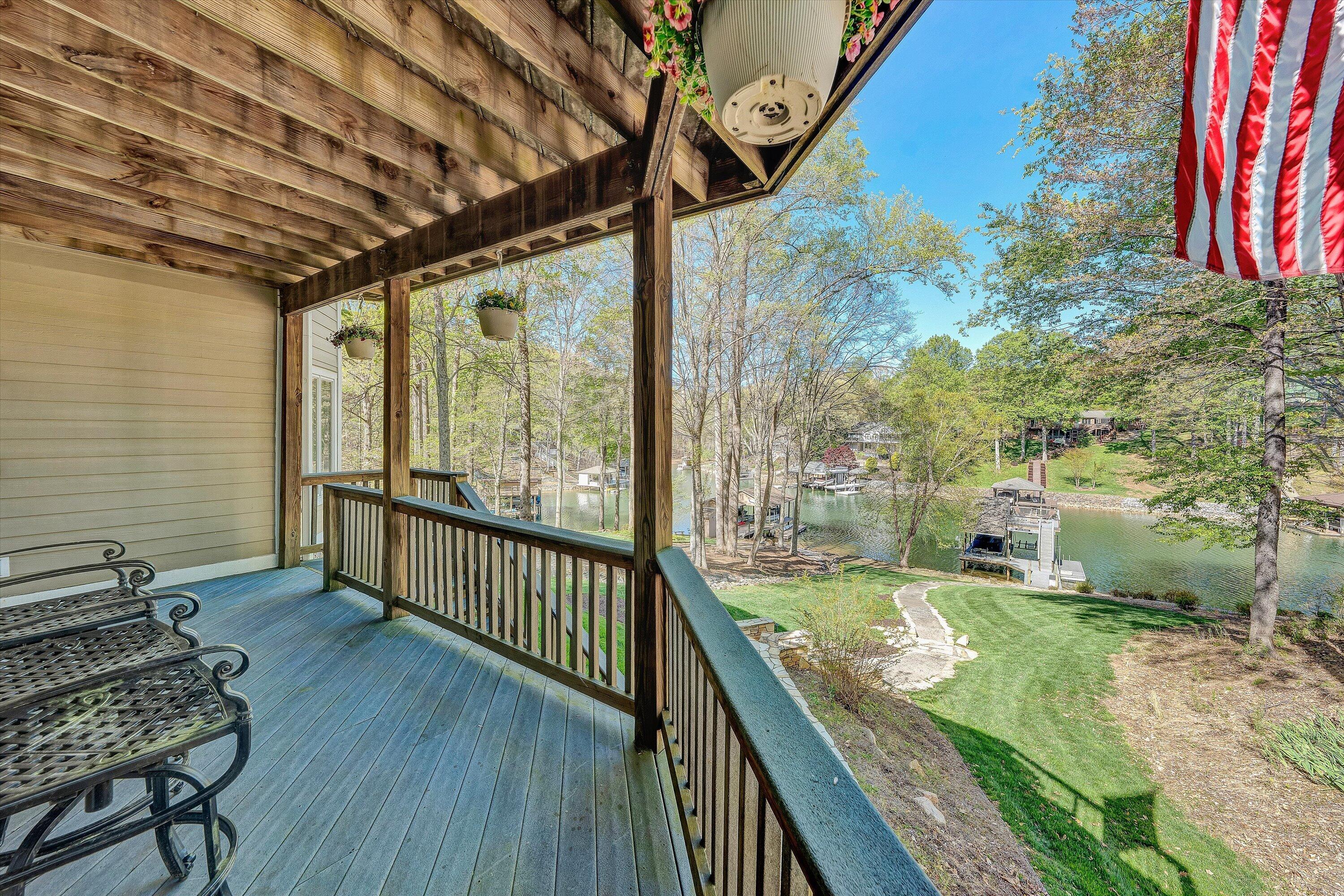 145 Channelview Drive Moneta, VA 24121 - Photo 58 of 62 a view of a porch with wooden floor and outdoor seating