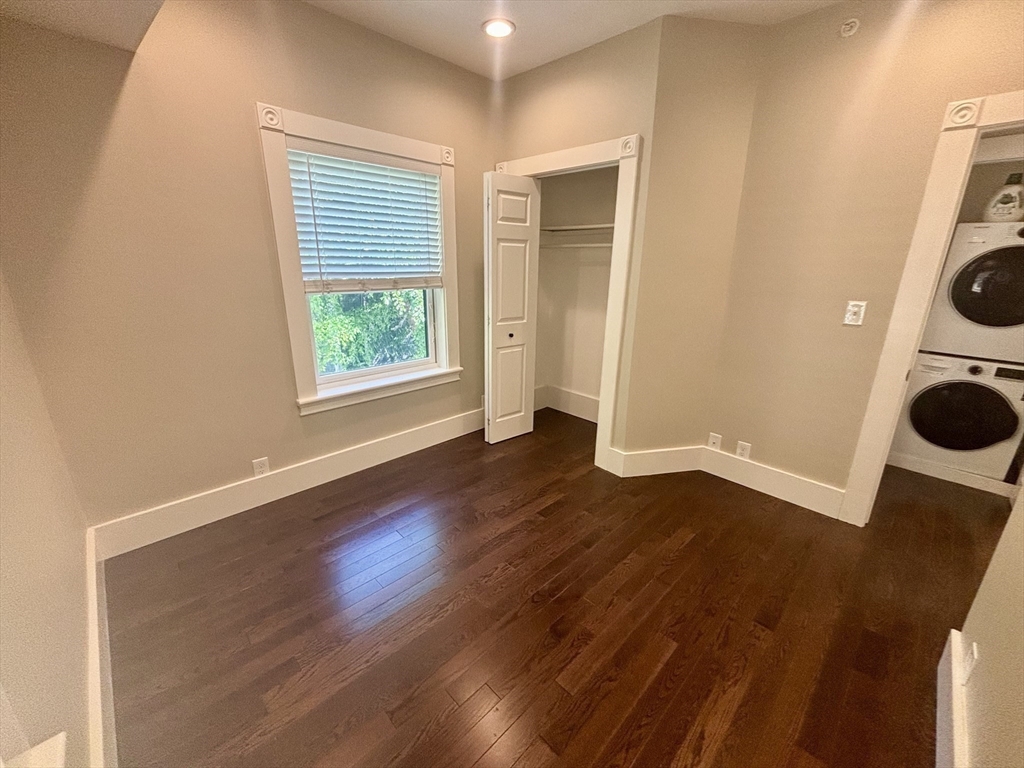 48 Magazine Street, Unit 3 Cambridge, MA 02139 - Photo 11 of 15 an empty room with wooden floor and washing machine