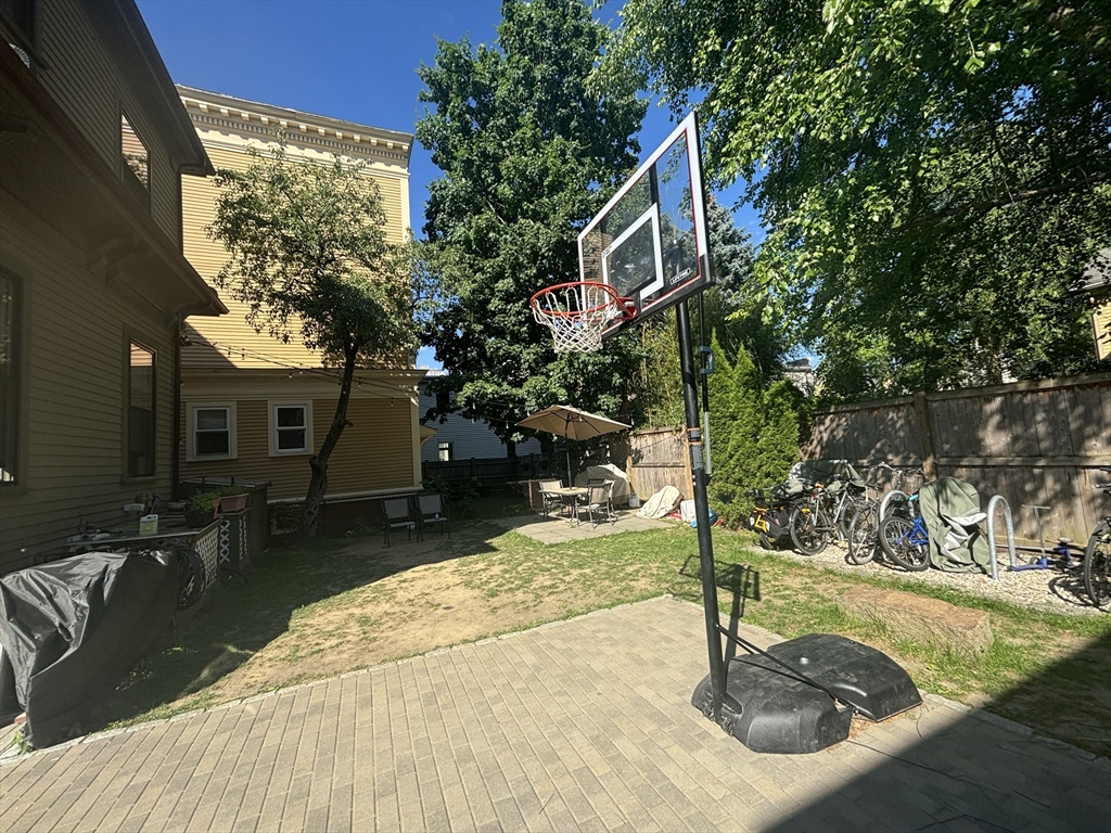 48 Magazine Street, Unit 3 Cambridge, MA 02139 - Photo 14 of 15 a house with trees in the background