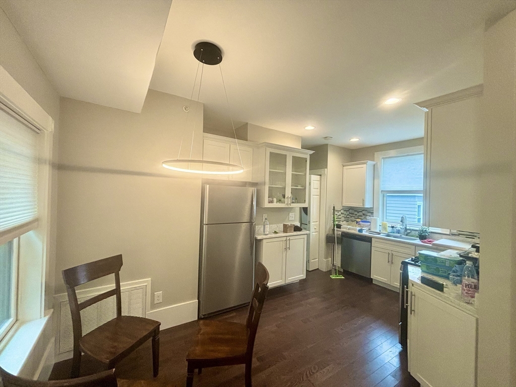 48 Magazine Street, Unit 3 Cambridge, MA 02139 - Photo 4 of 15 a room with a chair and wooden floor