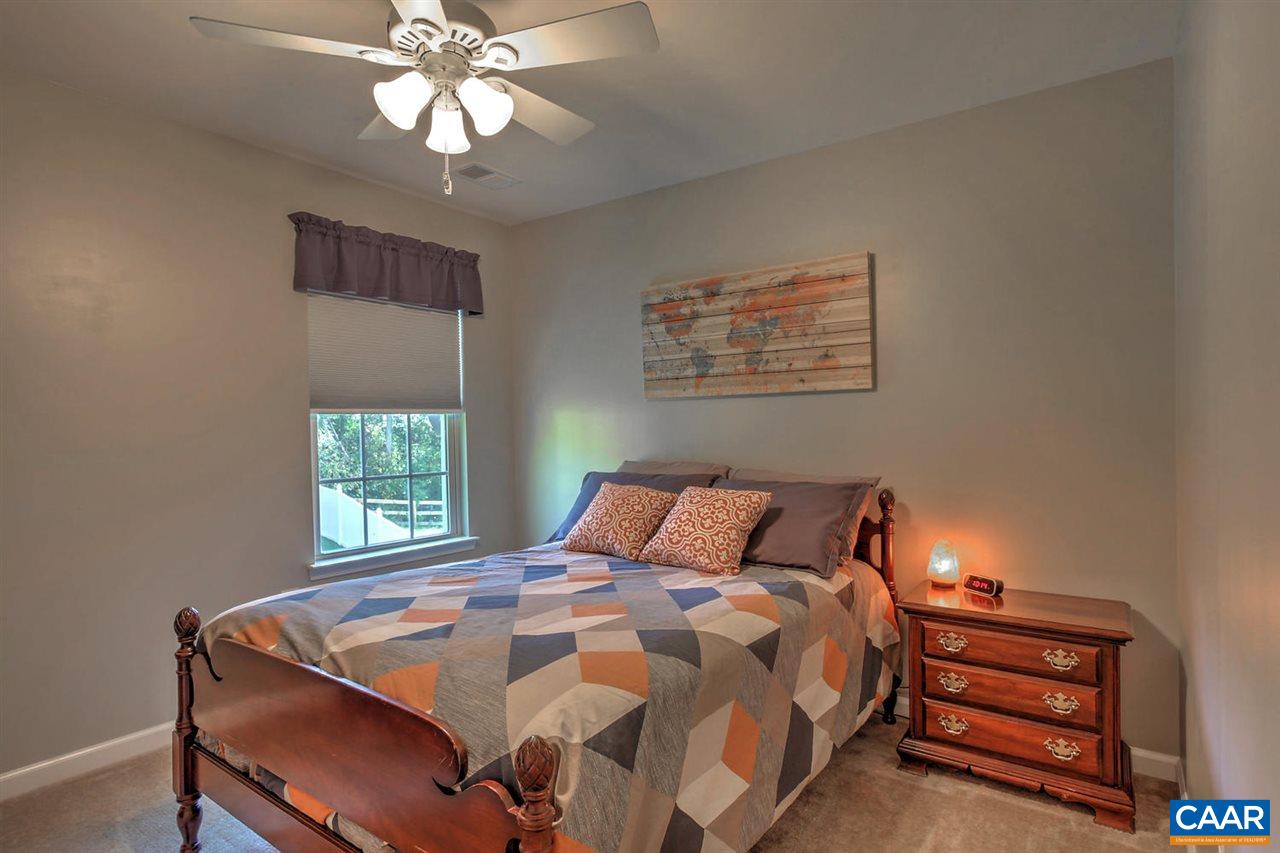84 Ridgemont Road Ruckersville, VA 22968 - Photo 20 of 26 a bedroom with a bed and a chandelier