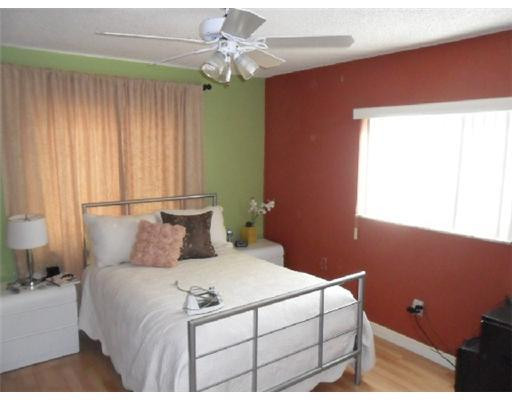 11154 Delta Circle Boca Raton, FL 33428 - Photo 2 of 6 a bedroom with a bed and a window