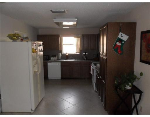 11154 Delta Circle Boca Raton, FL 33428 - Photo 3 of 6 a kitchen with refrigerator and window