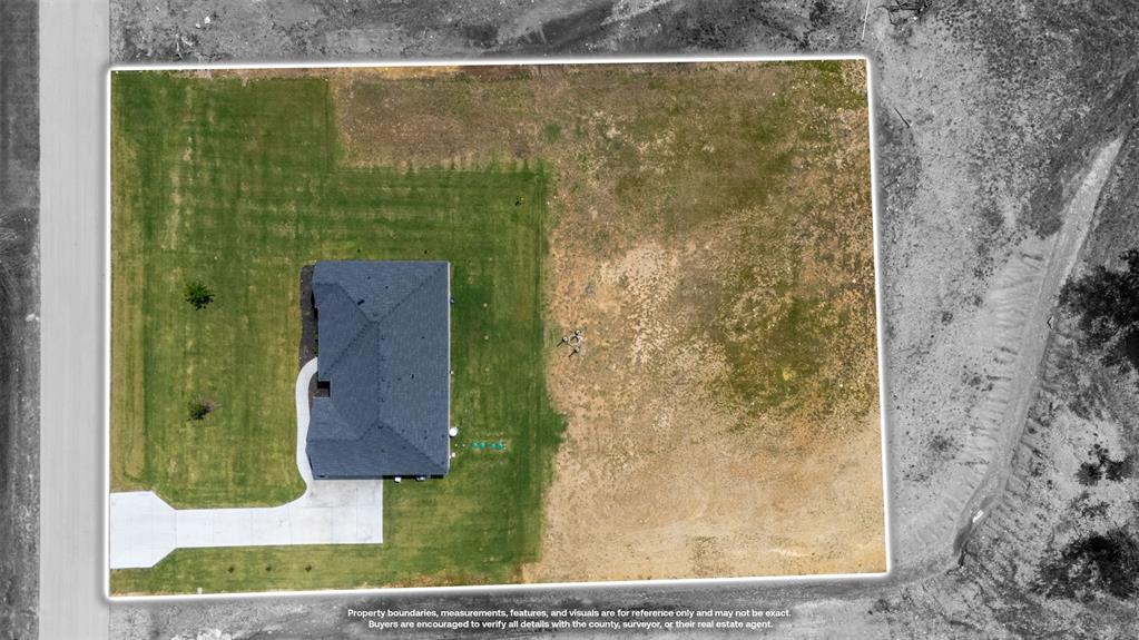 2004 Willy Dilly Road Springtown, TX 76082 - Photo 38 of 40 Aerial view showcasing a detached property with a dark shingle roof and a concrete driveway