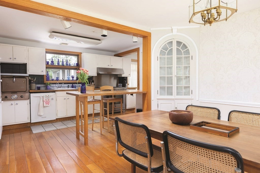 11 Ridgeway Terrace Newton, MA 02464 - Photo 4 of 10 a open kitchen with stainless steel appliances granite countertop a stove top oven a sink dishwasher and white cabinets with wooden floor