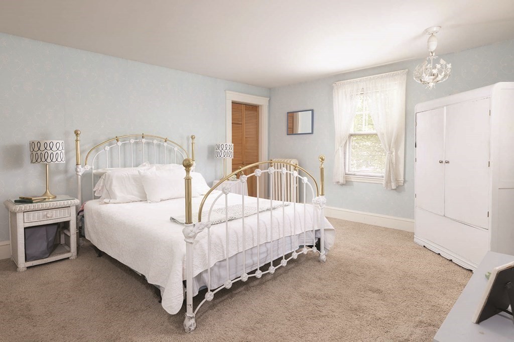 11 Ridgeway Terrace Newton, MA 02464 - Photo 5 of 10 a bed sitting in a spacious bedroom next to a window