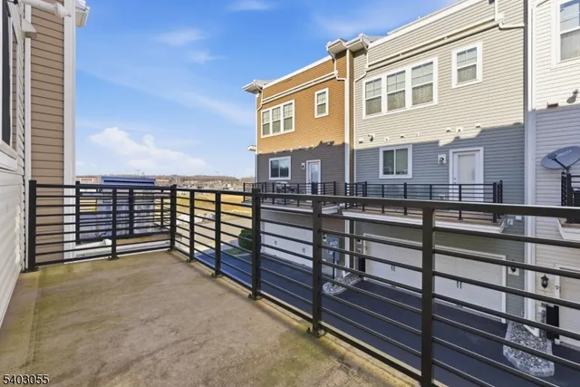 a view of a balcony with wooden floor and fence
