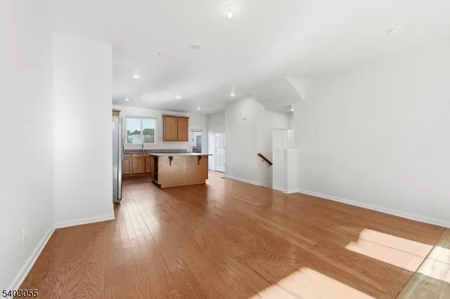 a view of a kitchen with a sink and a refrigerator