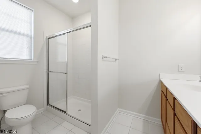 a bathroom with a shower a toilet and a sink