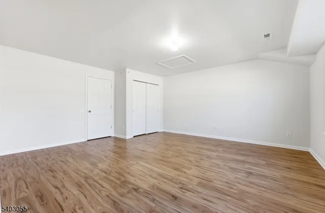 a view of an empty room and wooden floor
