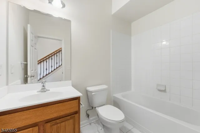 a bathroom with a sink toilet vanity and bathtub