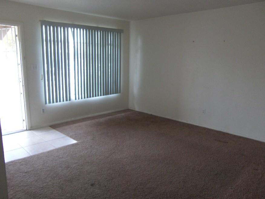 3743 West Lawrence Road Phoenix, AZ 85019 - Photo 4 of 4 an empty room with a window