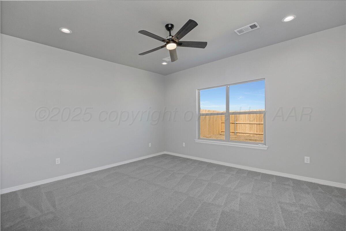 4206 Beacon Road Amarillo, TX 79118 - Photo 12 of 23 an empty room with ceiling fan and window