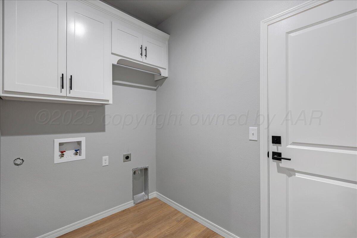4206 Beacon Road Amarillo, TX 79118 - Photo 19 of 23 a view of a kitchen with wooden floor and cabinet
