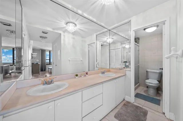 a bathroom with a double vanity sink mirror double and shower