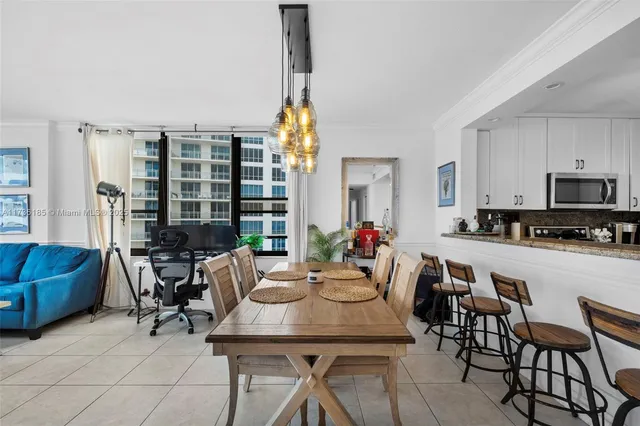 a view of a dining room with furniture and chandelier