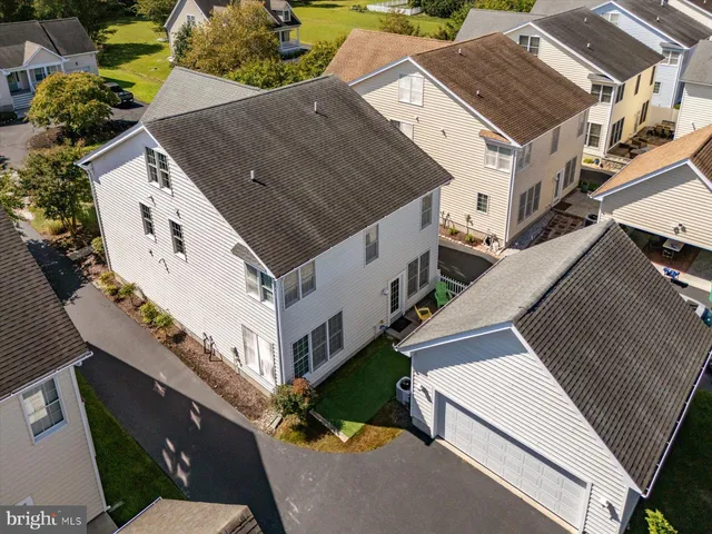 a living room with wooden floor and stairs
