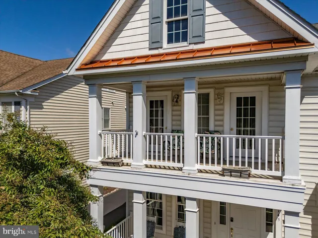 a view of a dining room with furniture a chandelier and wooden floor