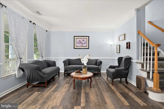a view of a hallway with wooden floor and entryway