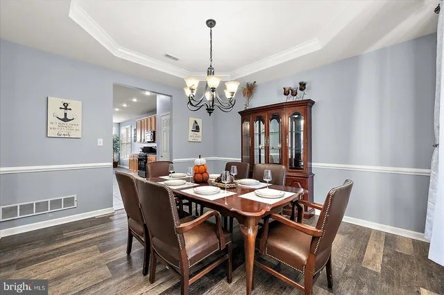 a spacious bedroom with a bed and wooden floor