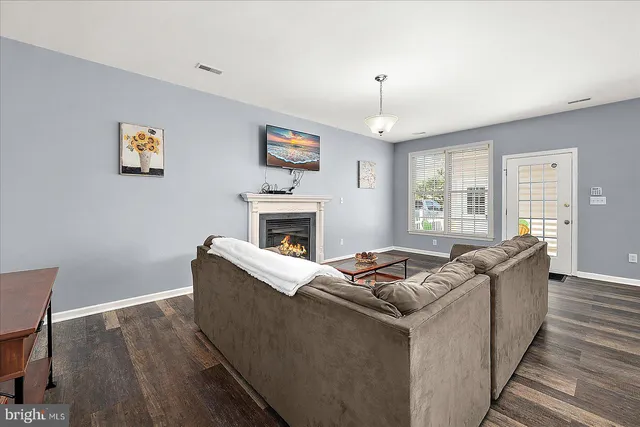 a view of a patio with couches chairs and wooden floor