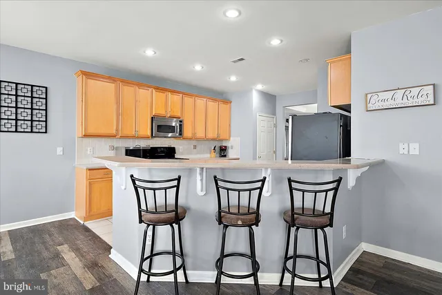 a front view of a house with a yard and potted plants
