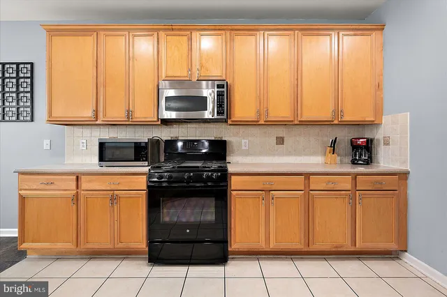 a room with wooden floor pool table and windows