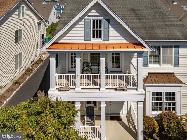 an aerial view of a house with a yard and potted plants