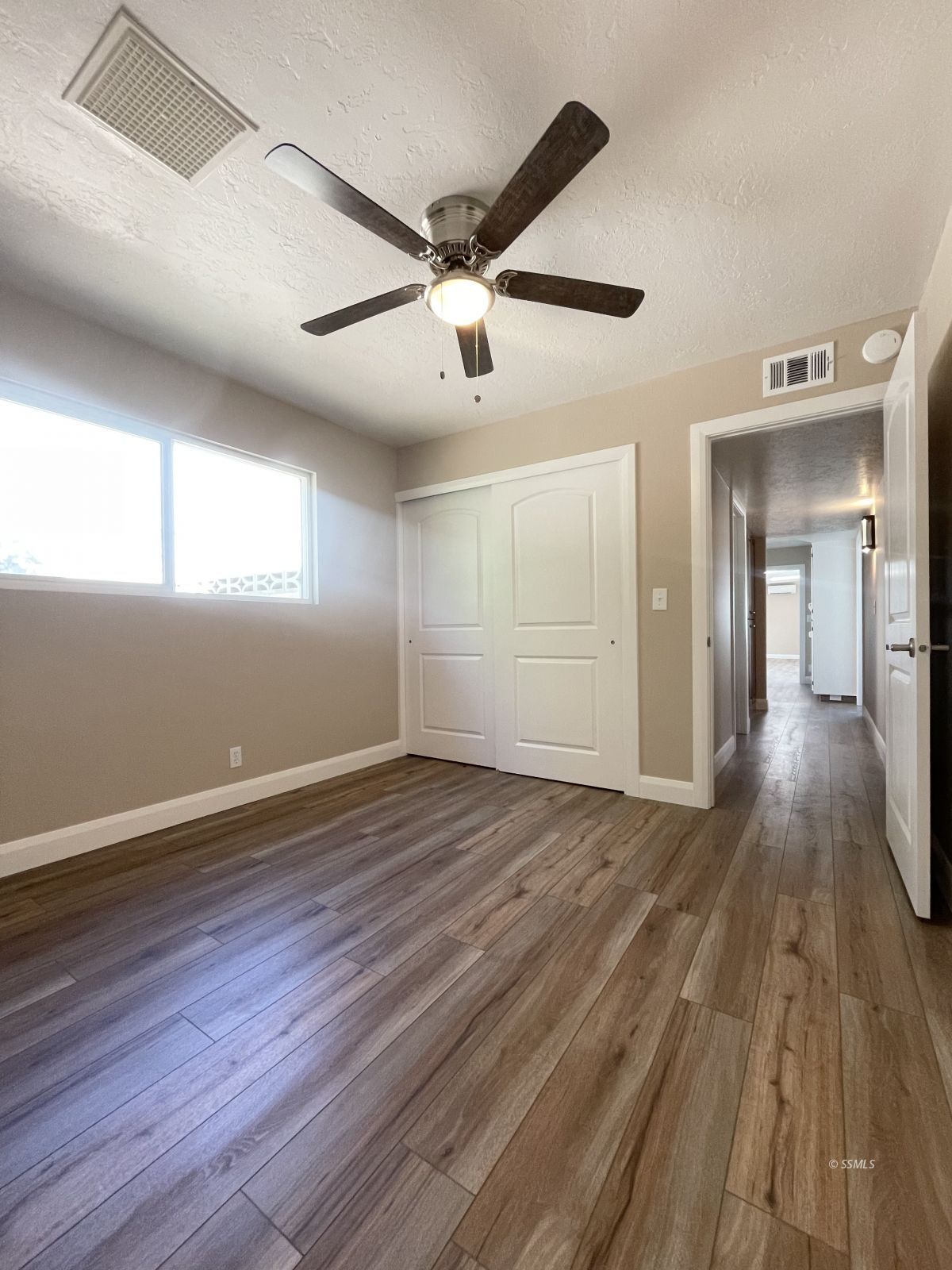 1031 North Sierra View Street Ridgecrest, CA 93555 - Photo 16 of 33 wooden floor in an empty room with a window