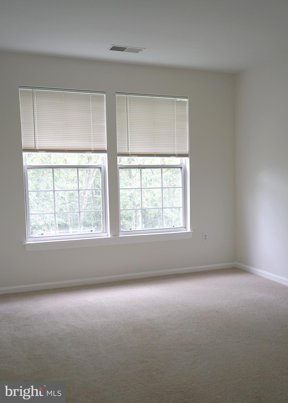 12004 Amber Ridge Circle, Unit B303 Germantown, MD 20876 - Photo 12 of 25 an empty room with a window
