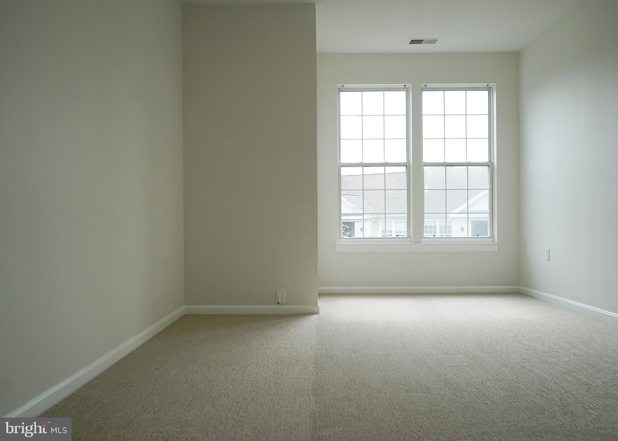 12004 Amber Ridge Circle, Unit B303 Germantown, MD 20876 - Photo 14 of 25 an empty room with a window