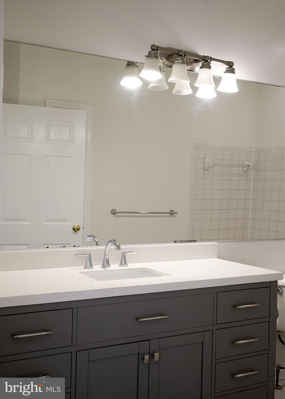 12004 Amber Ridge Circle, Unit B303 Germantown, MD 20876 - Photo 15 of 25 a bathroom with a sink and a mirror