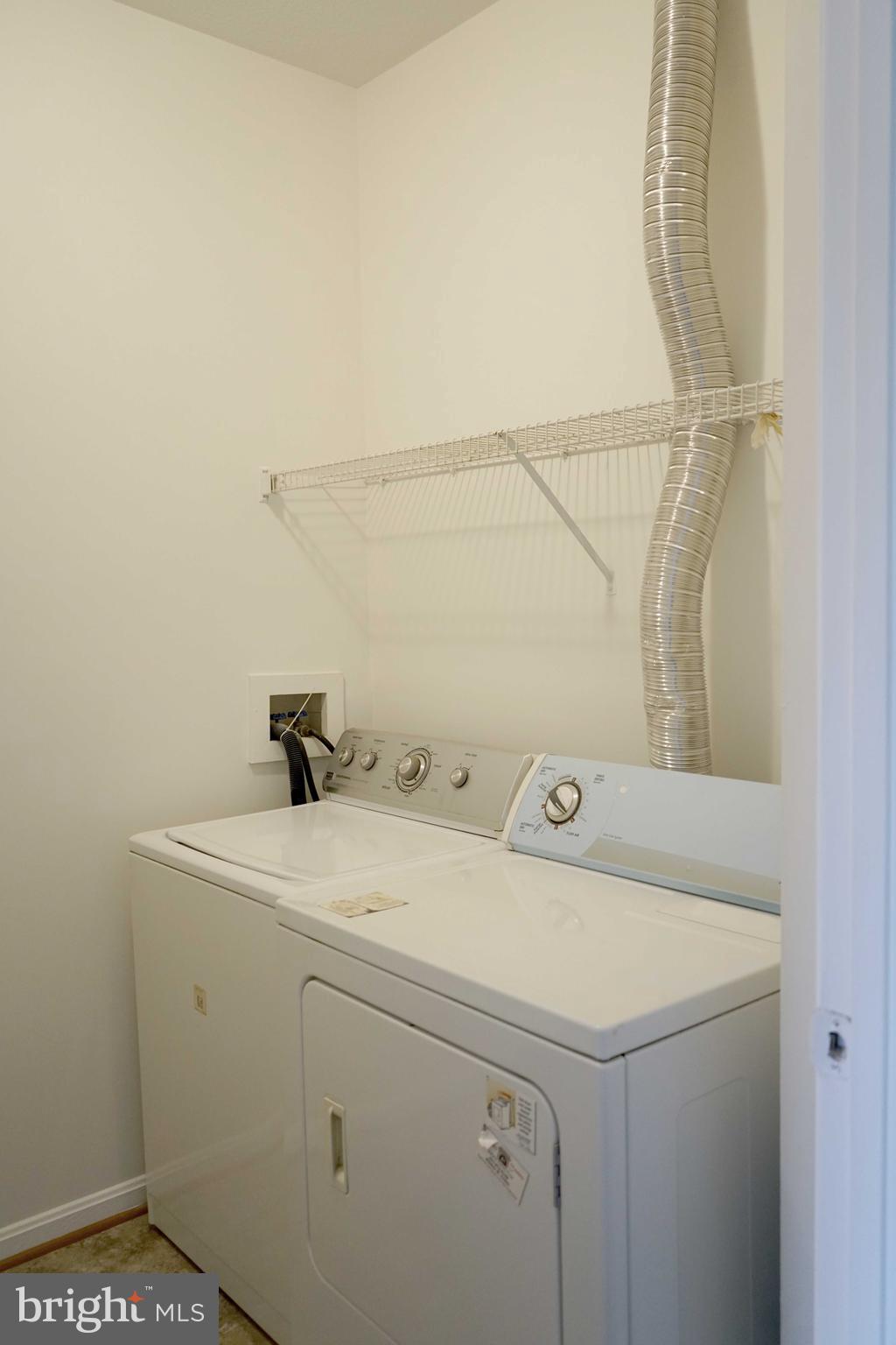 12004 Amber Ridge Circle, Unit B303 Germantown, MD 20876 - Photo 19 of 25 a utility room with dryer and washer