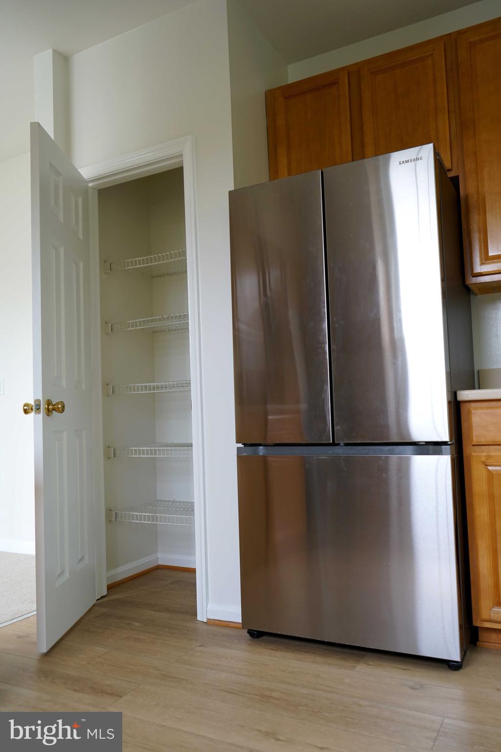 12004 Amber Ridge Circle, Unit B303 Germantown, MD 20876 - Photo 24 of 25 a white refrigerator freezer sitting in a kitchen