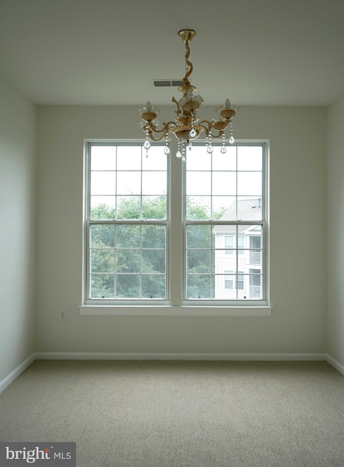 12004 Amber Ridge Circle, Unit B303 Germantown, MD 20876 - Photo 5 of 25 an empty room with a window