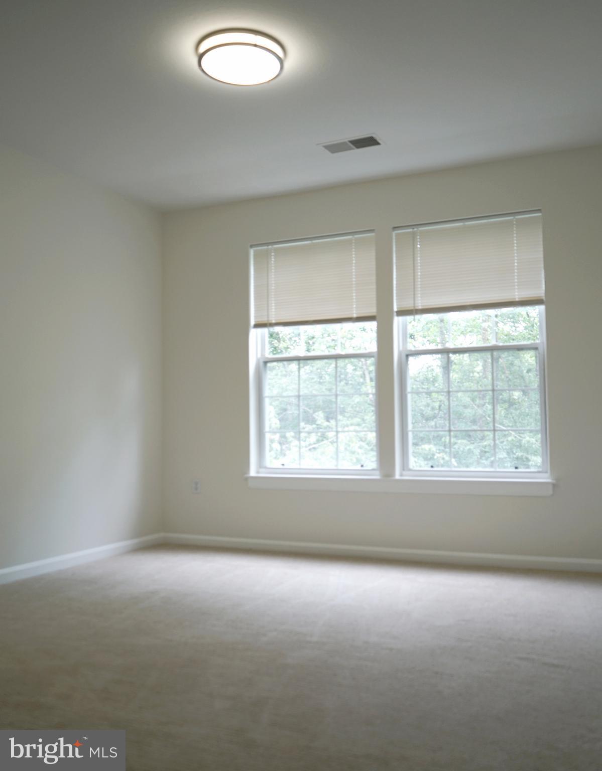 12004 Amber Ridge Circle, Unit B303 Germantown, MD 20876 - Photo 7 of 25 an empty room with a window