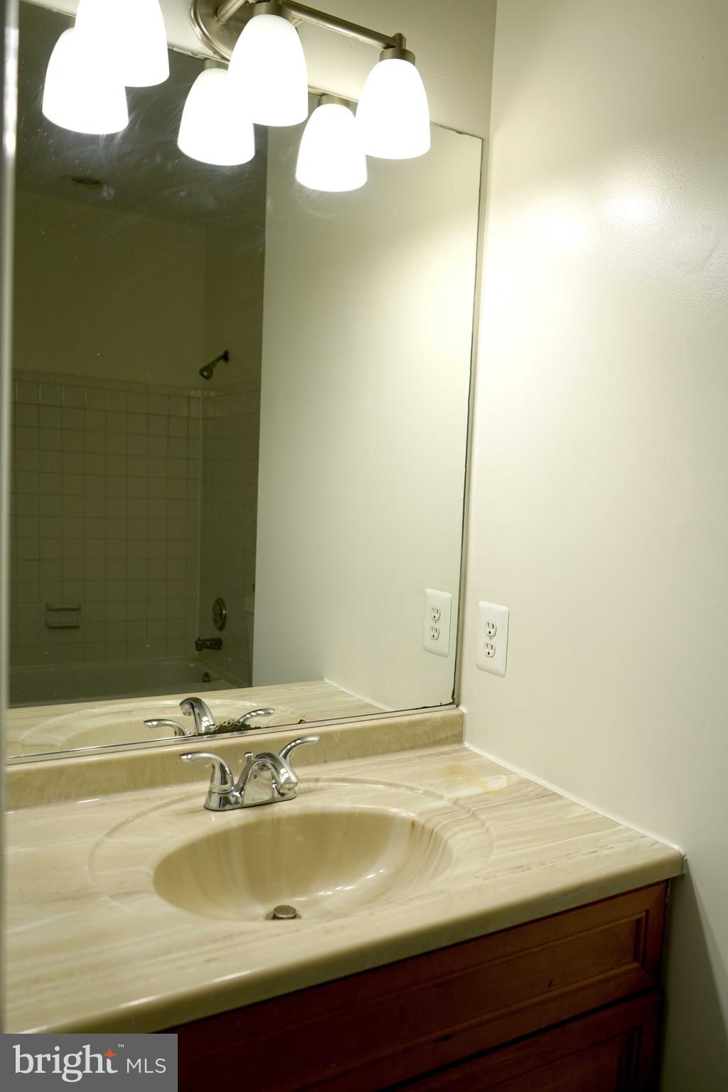12004 Amber Ridge Circle, Unit B303 Germantown, MD 20876 - Photo 10 of 25 a bathroom with a sink and a mirror