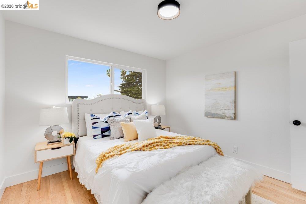 1298 Ribbon Street Foster City, CA 94404 - Photo 54 of 86 Bright bedroom with light wood-finish flooring, white walls, and a large window