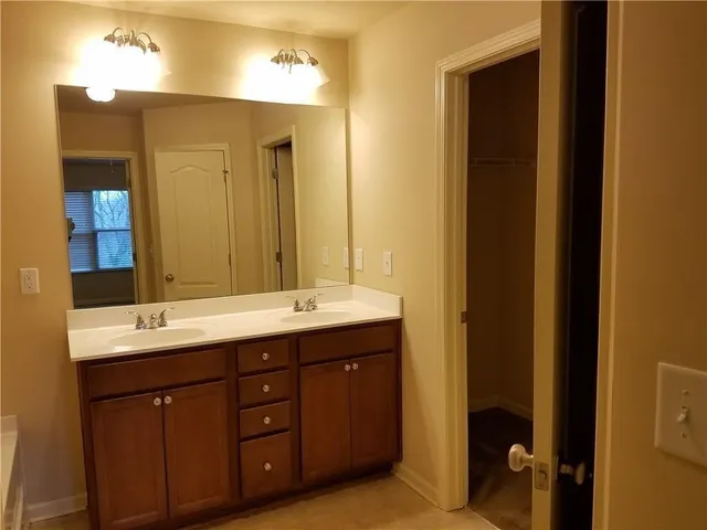 a bathroom with a double vanity sink and mirror